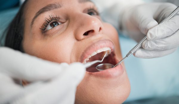 Woman, teeth and mouth at dentist with tools for dental cosmetics, healthcare assessment and medica.